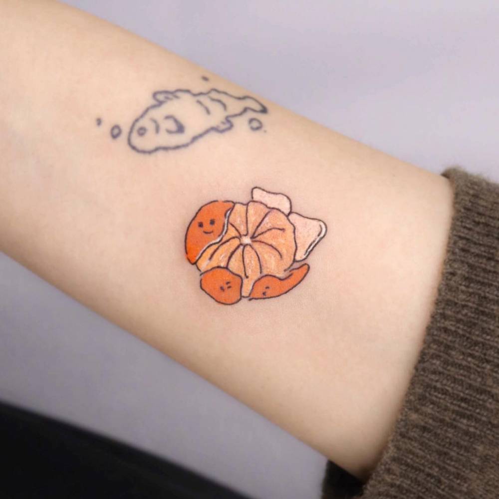 Kawaii style tangerine tattoo located on the inner