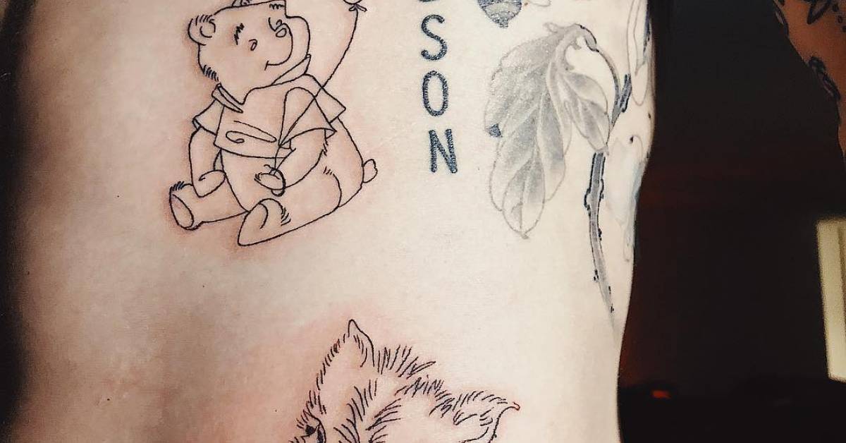 Winnie the Pooh holding a balloon and a piglet signed