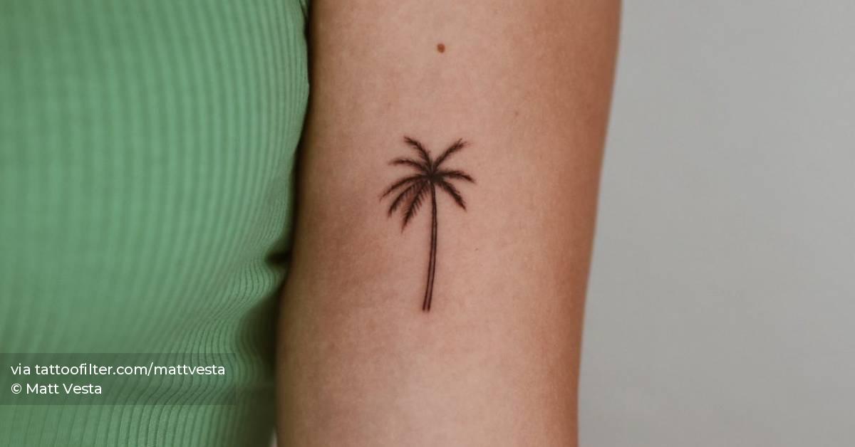 Palm tree tattoo located on the bicep.