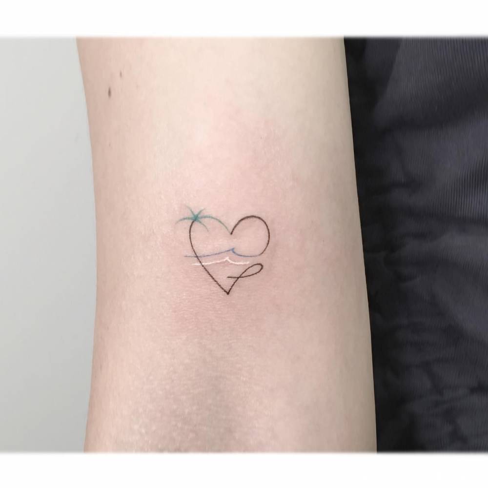 Minimalistic style beach heaty tattoo located on the