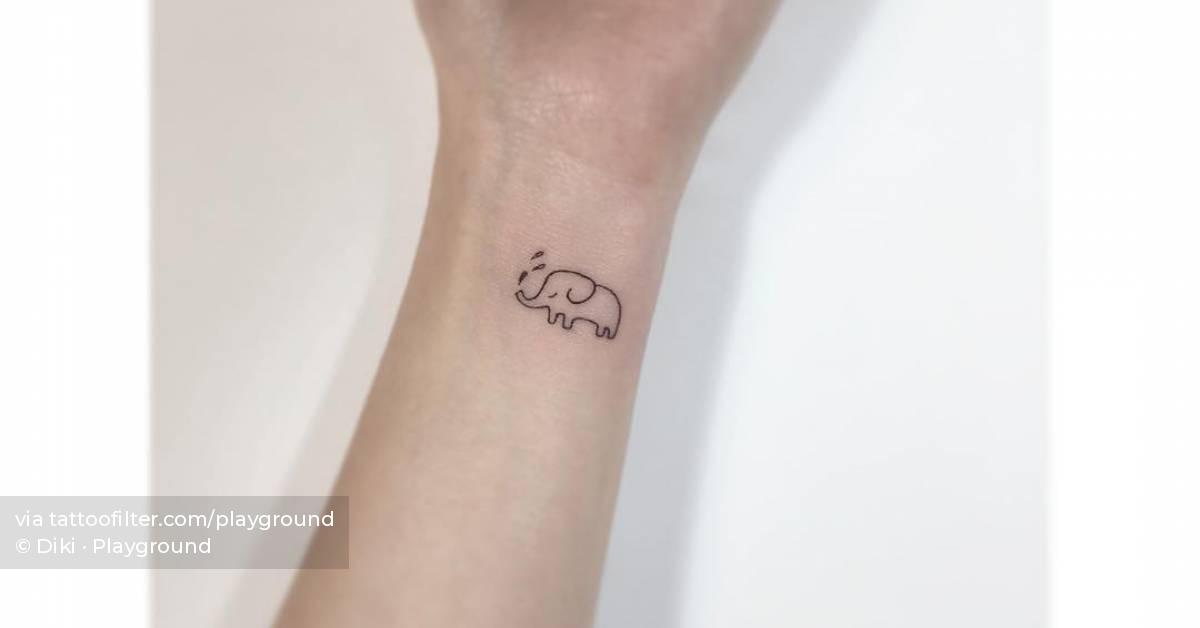 Tiny elephant tattoo located on the wrist.