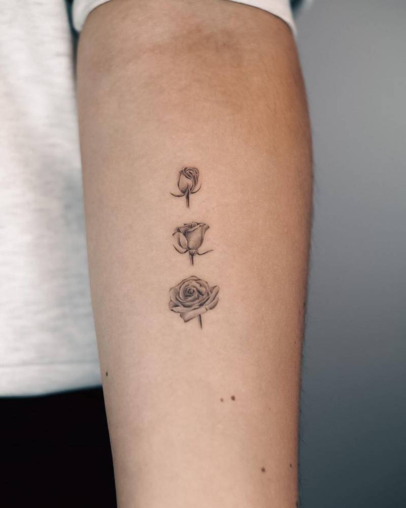 Blooming rose tattoo located on the inner forearm.