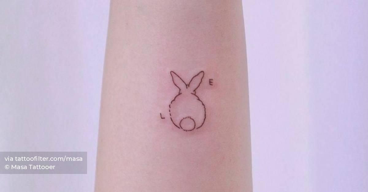 Fine line bunny tattoo forming the word "love".