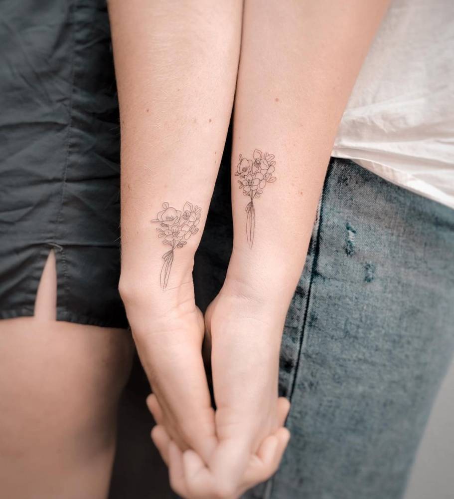 Matching fine line flower bouquet tattoo for couple.