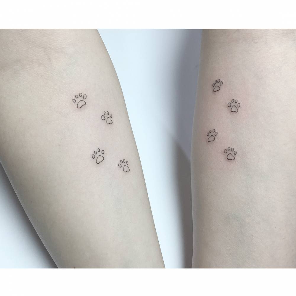 Matching dog paws tattoo for best friends.