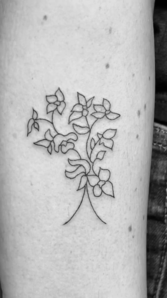 Line art flowers tattoo done on the inner forearm.