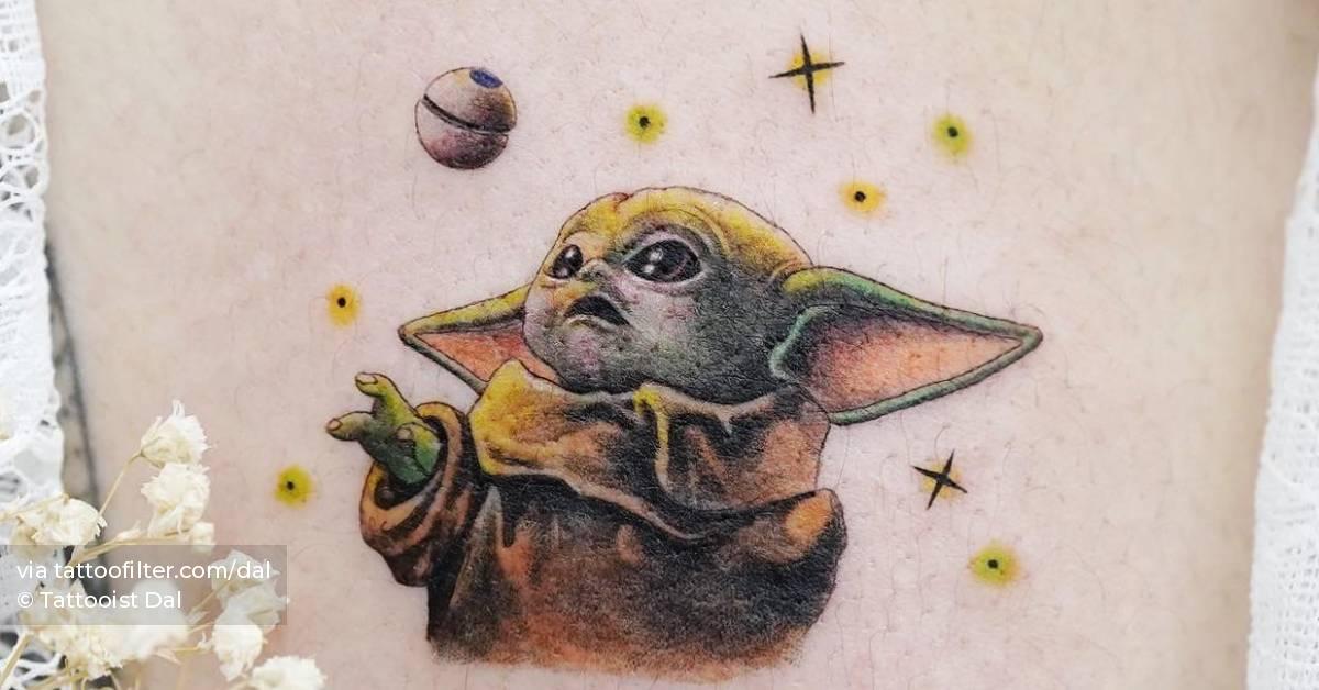 Baby Yoda tattoo located on the inner arm.
