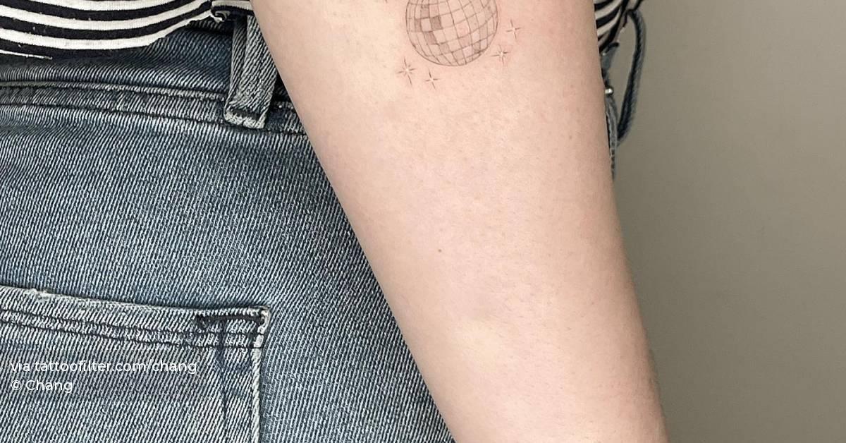 Fine line disco ball tattoo located on the forearm.