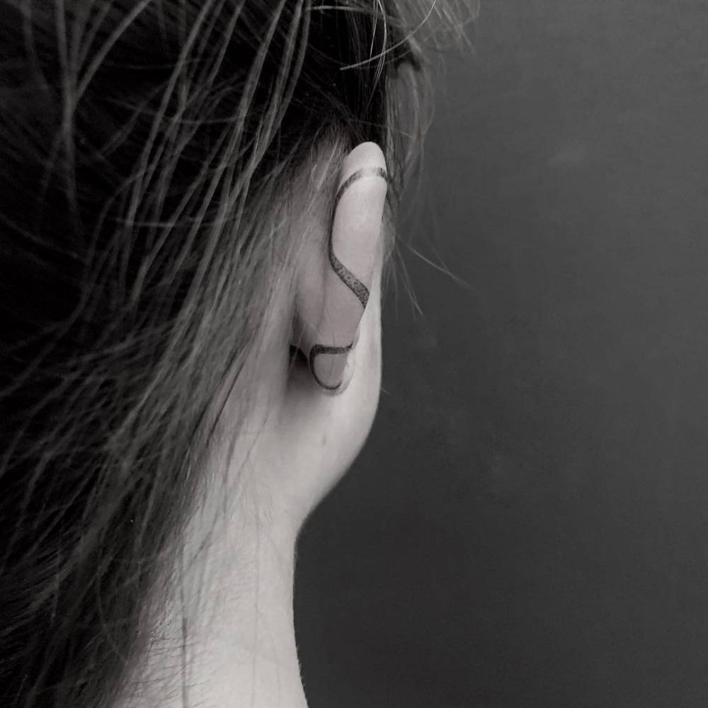 Snake tattoo on the ear.