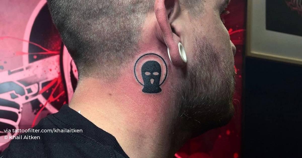 Balaclava tattoo located behind the ear.