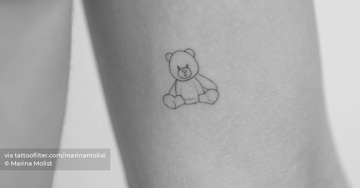 Fine line little teddy bear tattoo located on the inner