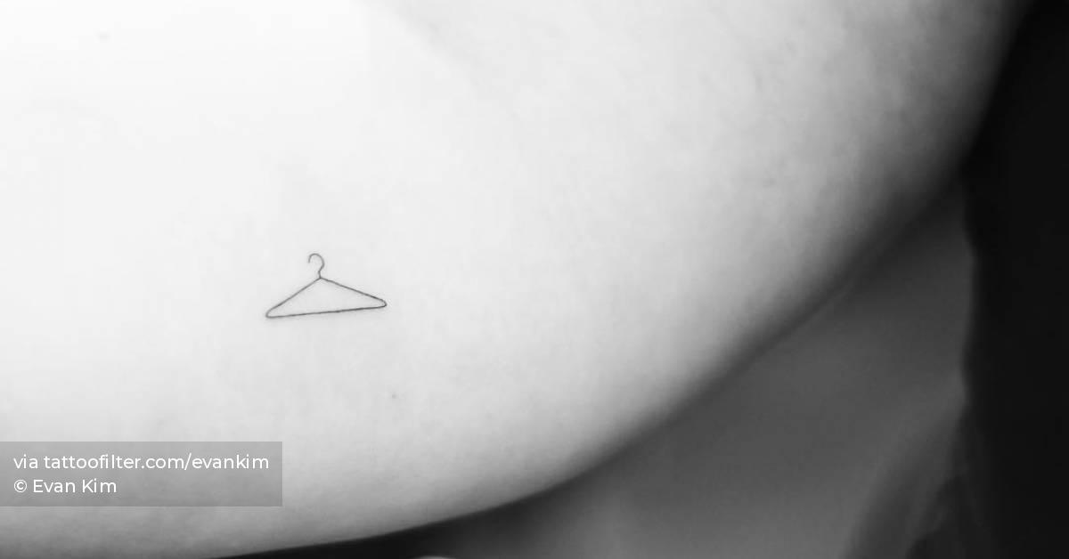 Fine line hanger tattoo placed on the inner forearm.