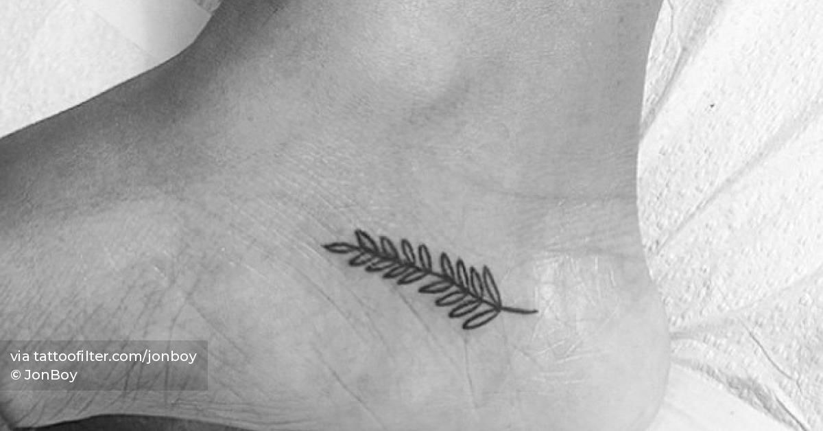 Minimalistic leaves tattoo located on the ankle.