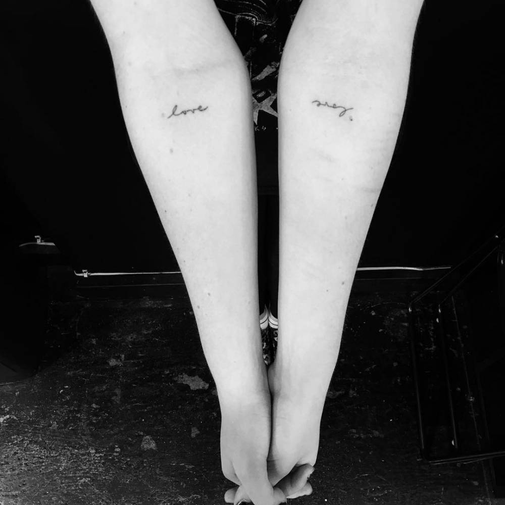Individual matching tattoo of the word "love".