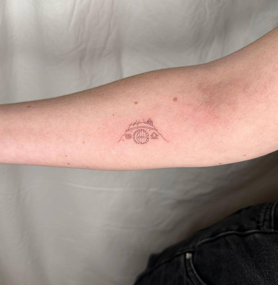 Single needle Hobbit house tattoo located on the inner