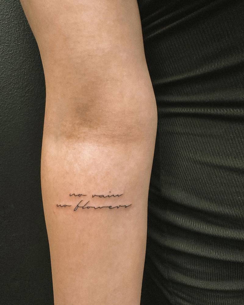 "No rain, no flowers" lettering tattoo handwritten on