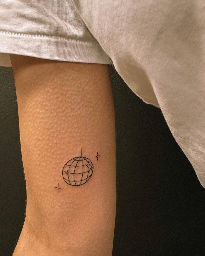 Fine line style disco ball tattoo placed on the inner