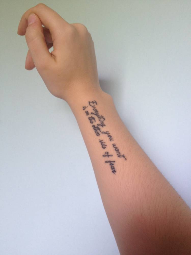 Forearm tattoo saying "Everything you want is on the