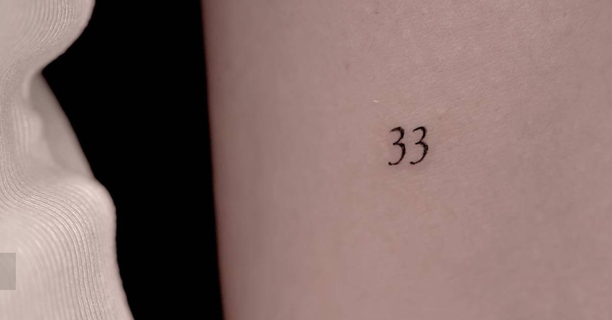 Tattoo of the number "33" done on the inner forearm.(07)