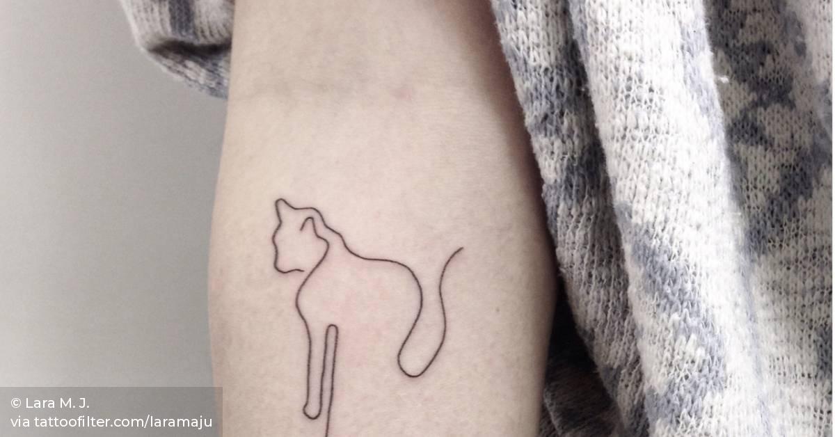 Handpoked cat tattoo on the right forearm.