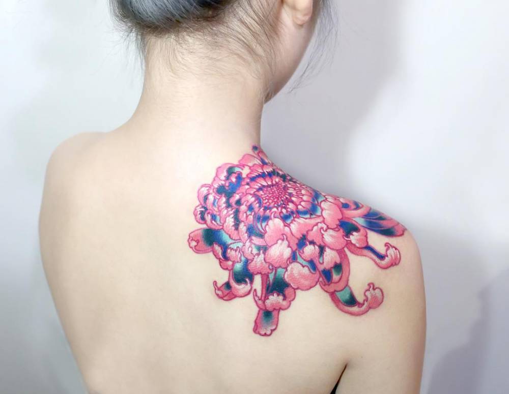 Chrysanthemum tattoo on the right shoulder.