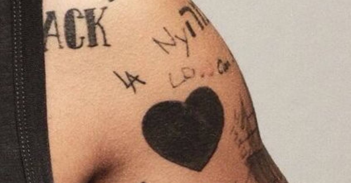 Coat hanger tattoo on Harry Styles' left arm, by his