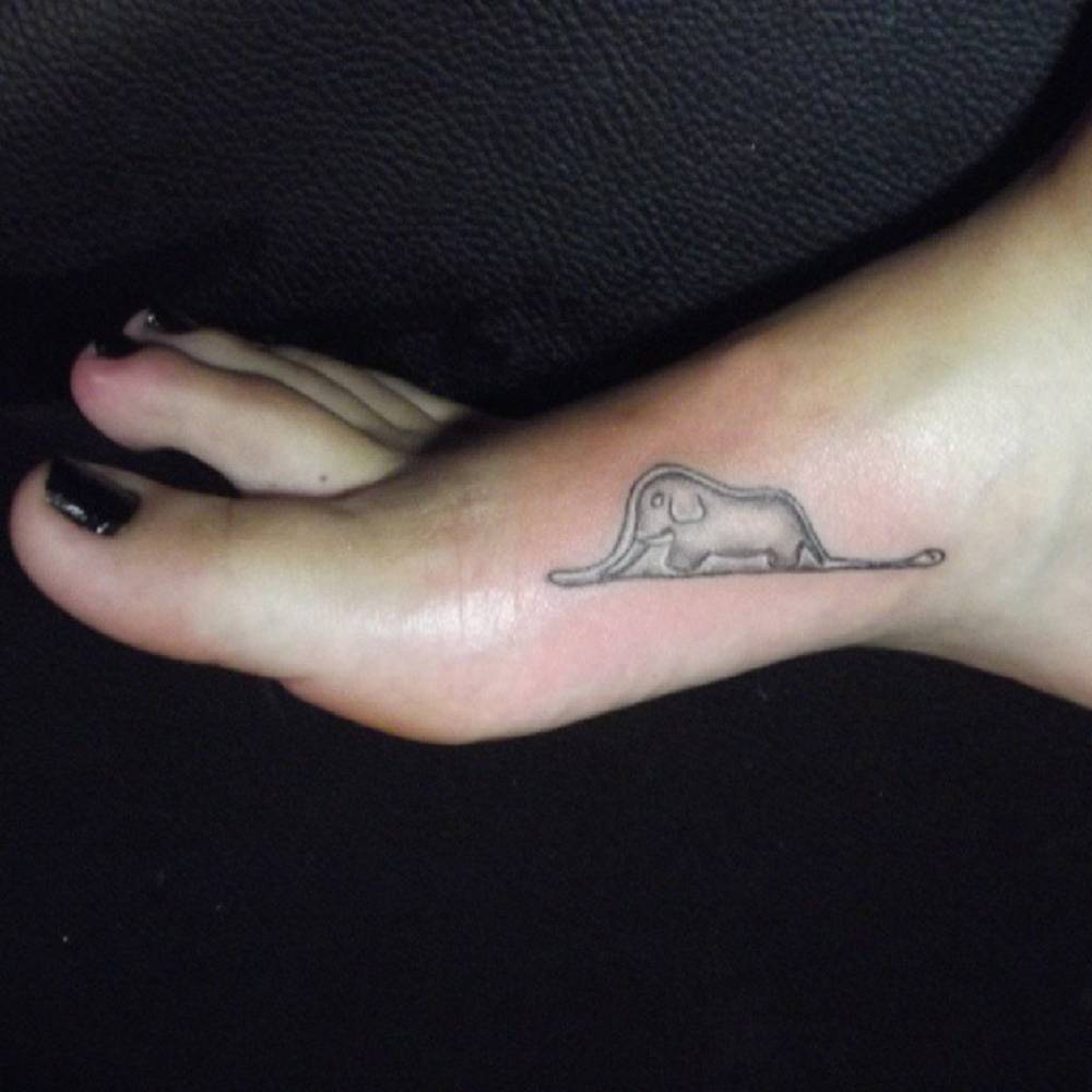 Inner foot tattoo of a boa constrictor with an elephant