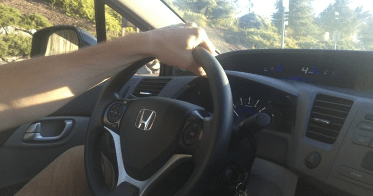 Why do men drive with one hand at the top of the steering wheel