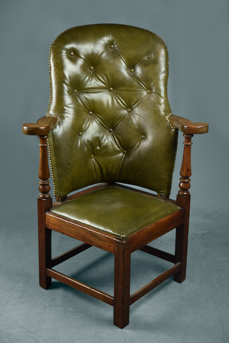 High back corner chair, covered in green buttoned leather with drop in