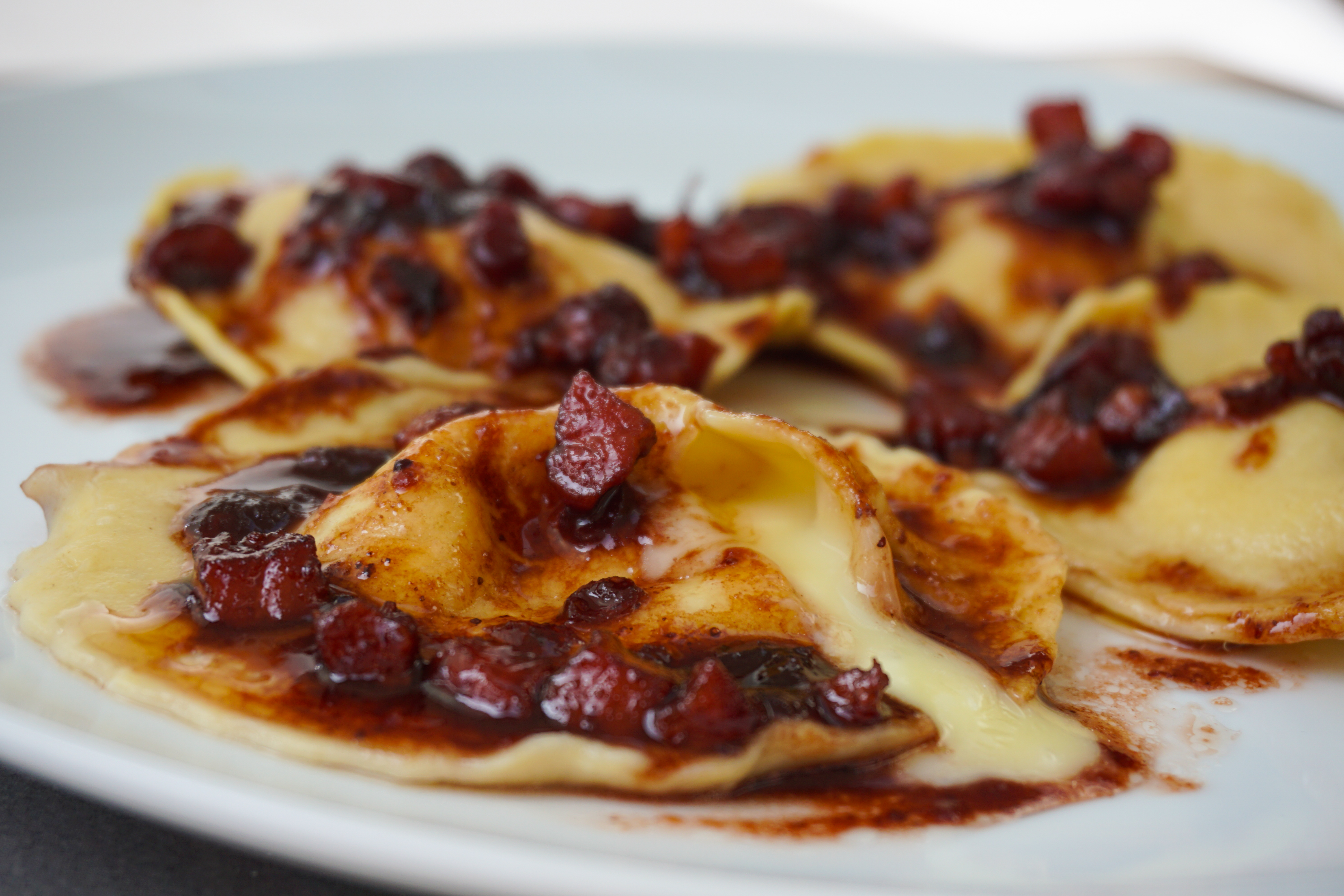 camembert ravioli with a port, cranberry and pancetta sauce