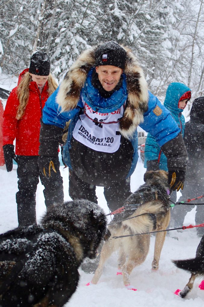 Larry Daugherty scratches at Kaltag checkpoint Iditarod