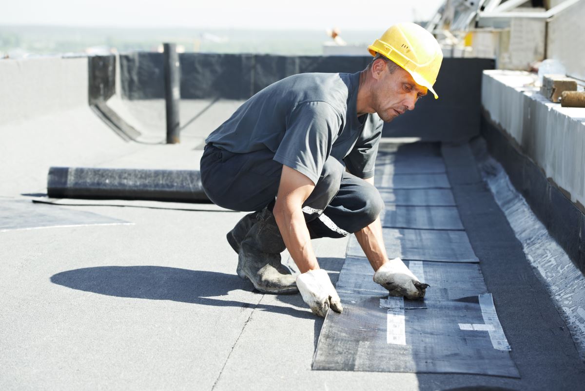 Roofer working on a commercial or industrial building Christensen