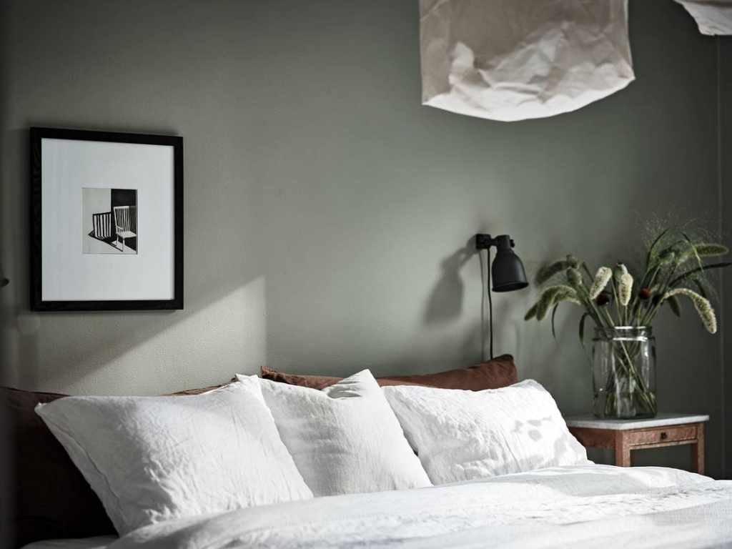 Cozy bedroom with a green wall