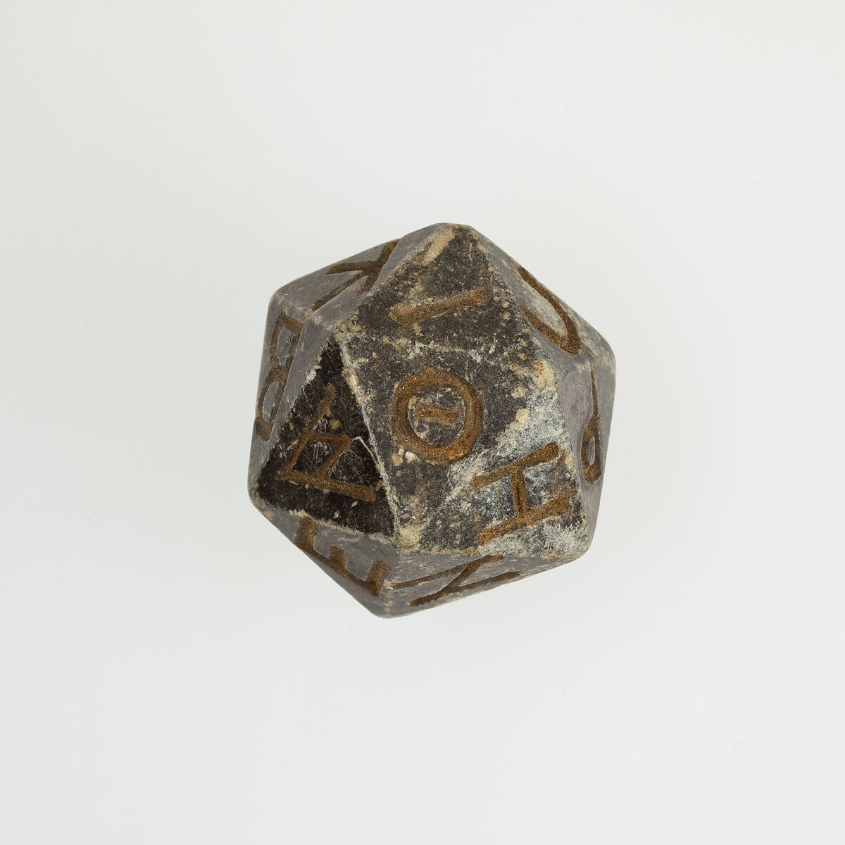 Twentysided die (icosahedron) with faces inscribed with Greek letters