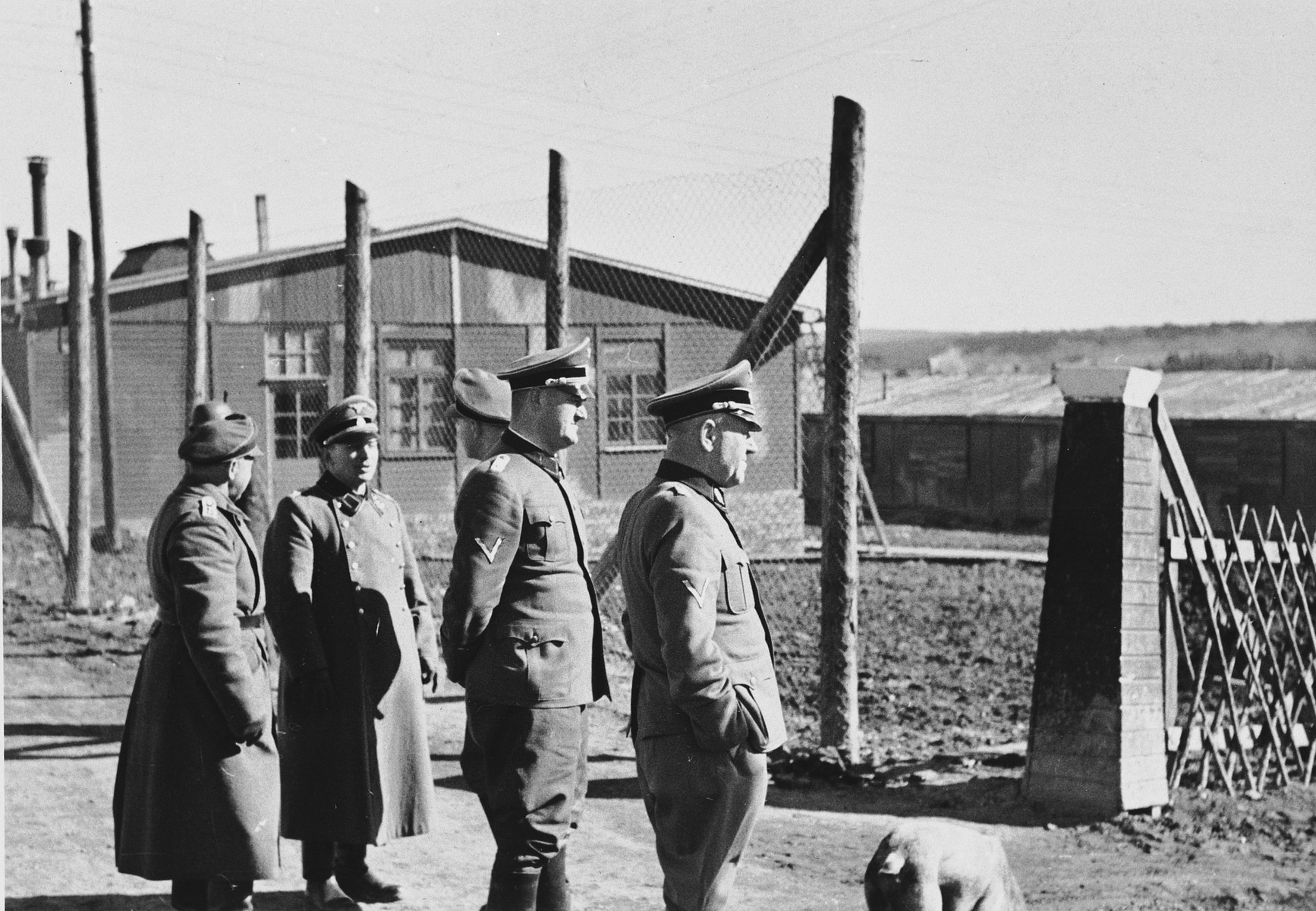 A group of SS officers tour the Hinzert concentration camp