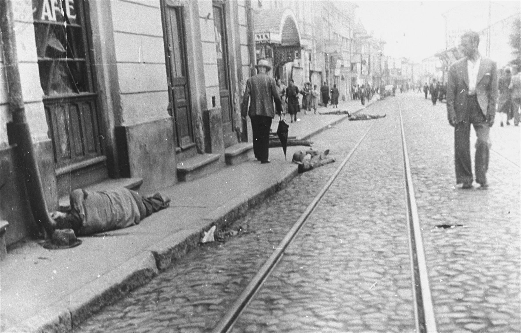 Civilians walk along Cuza Voda Street in central Iasi, near the Cinema