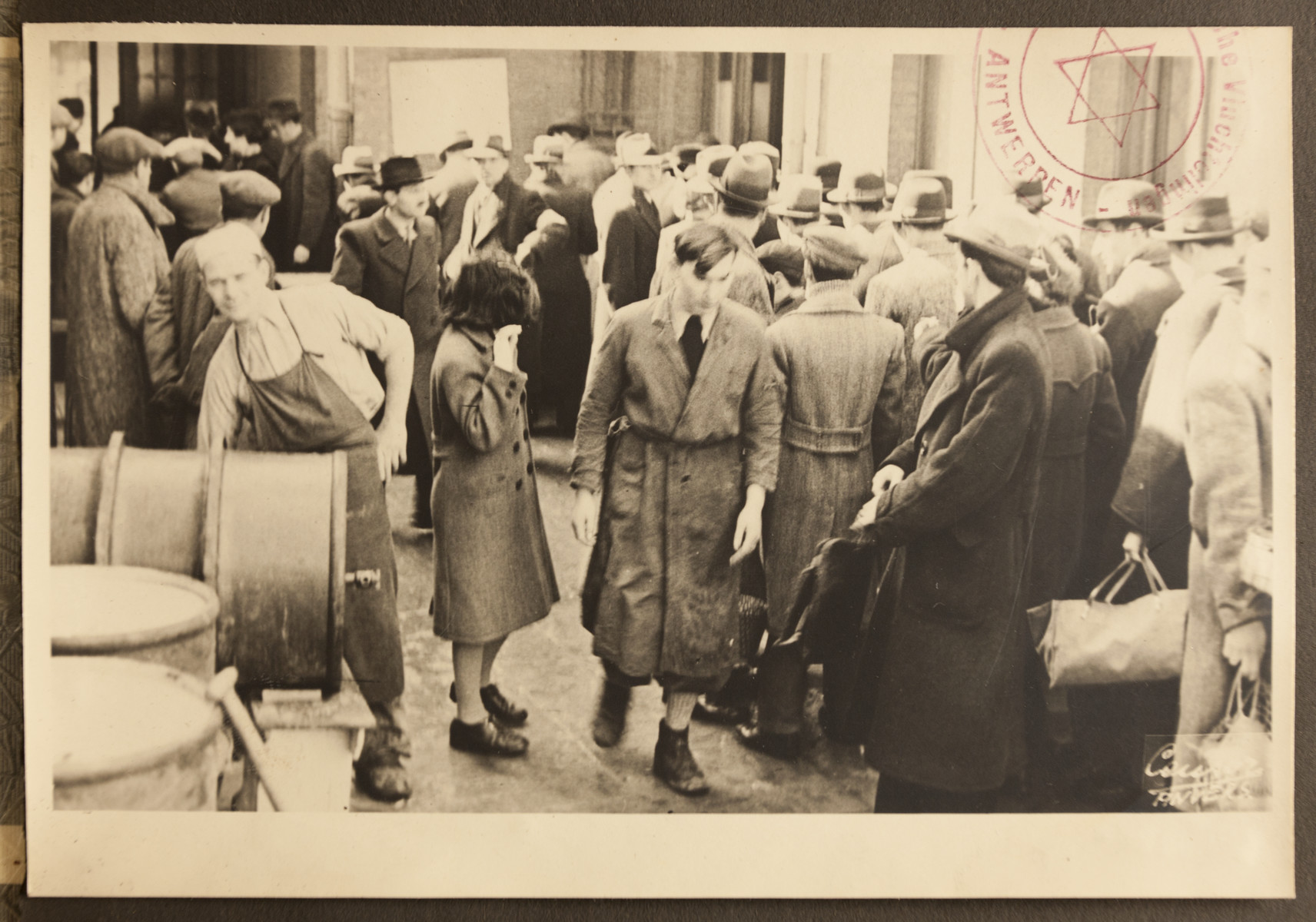 Refugees gather outside the facilities of the Jewish Refugee Aid
