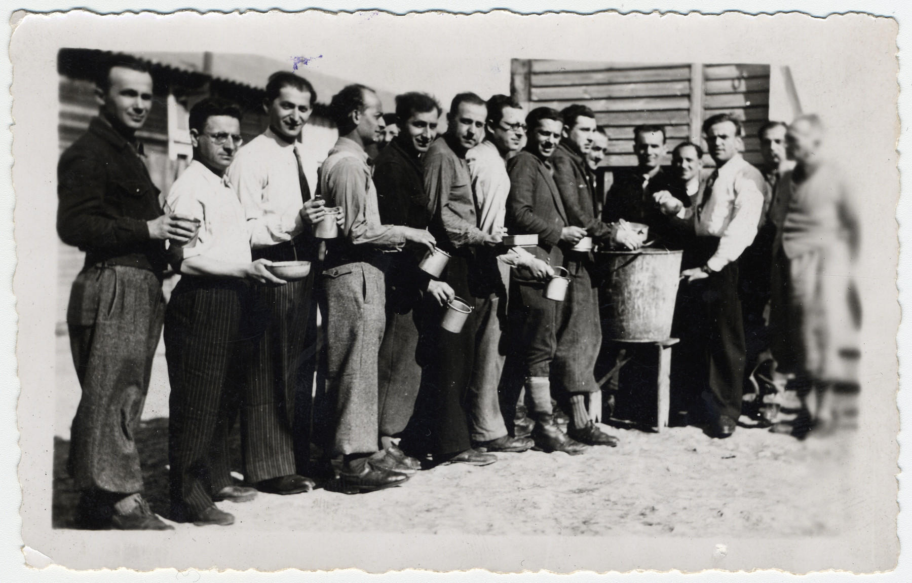 Prisoners wait in line for their rations in the BeaunelaRolande