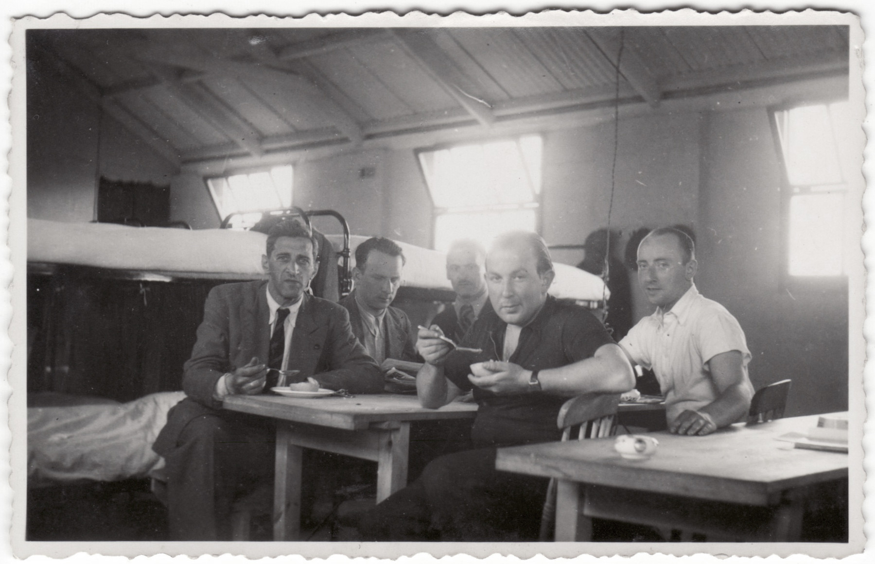 Jewish refugees eat a meal in their barracks in the Kitchener refugee