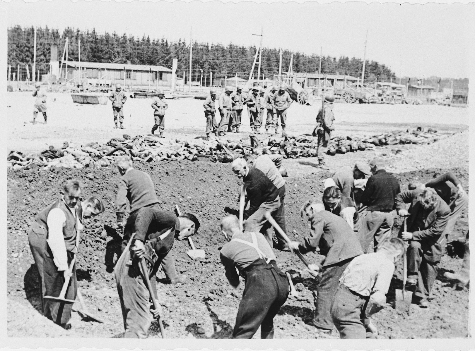 Civilians from the nearby town of Landsberg are forced to bury corpses