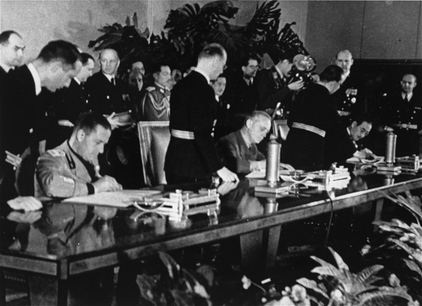 Representatives of the governments of Italy, Germany, and Japan sign