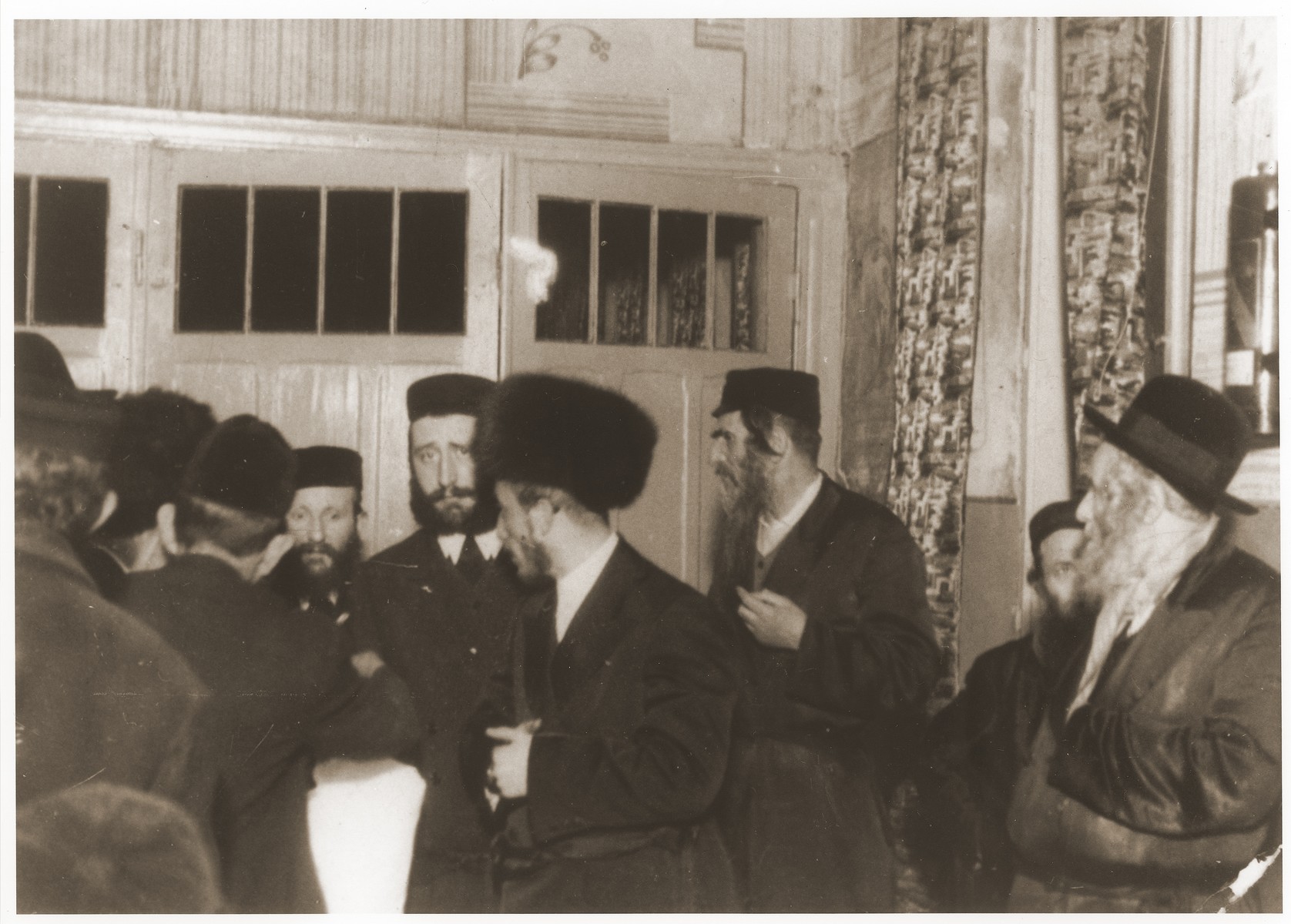 Ger Hasidim, including the rebbe, gather to greet the bridegroom before