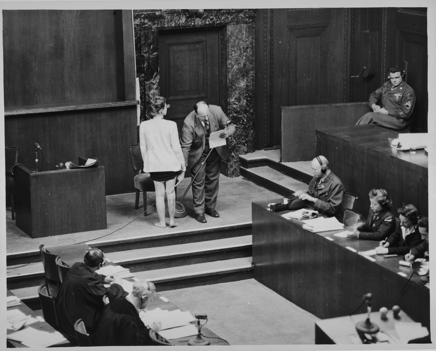 Polish survivor Jadwiga Dzido shows her scarred leg to the court, while