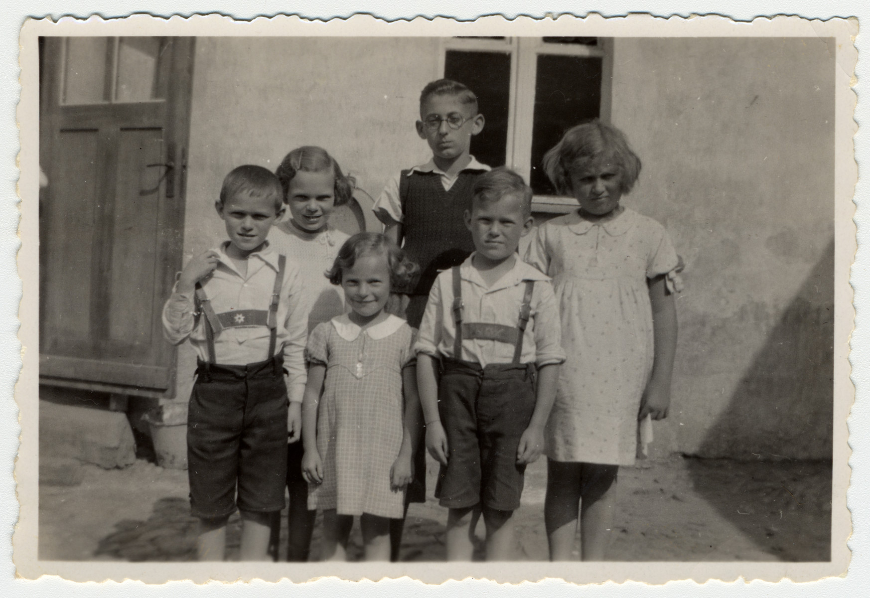 Six GermanJewish children pose in front of a building. Collections