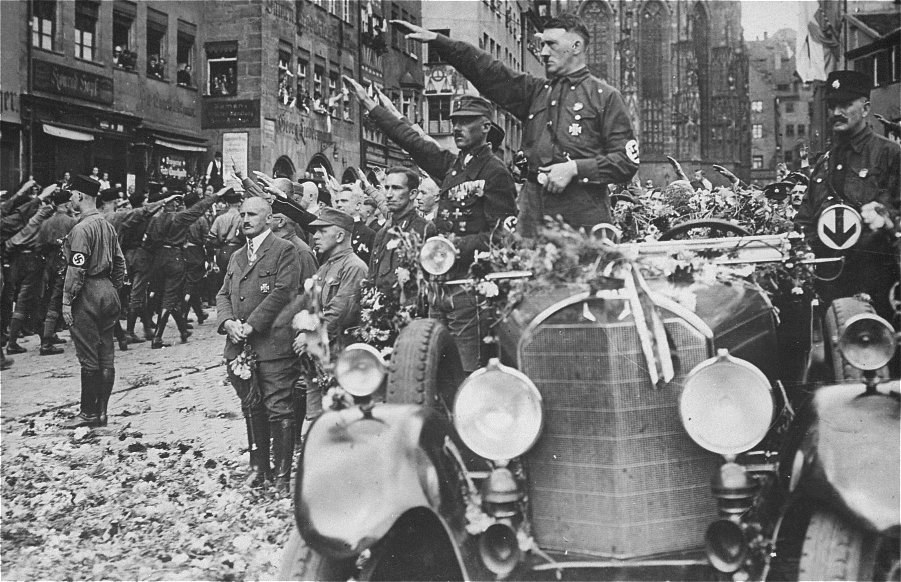 Adolf Hitler salutes a passing SS formation at the third Nazi Party