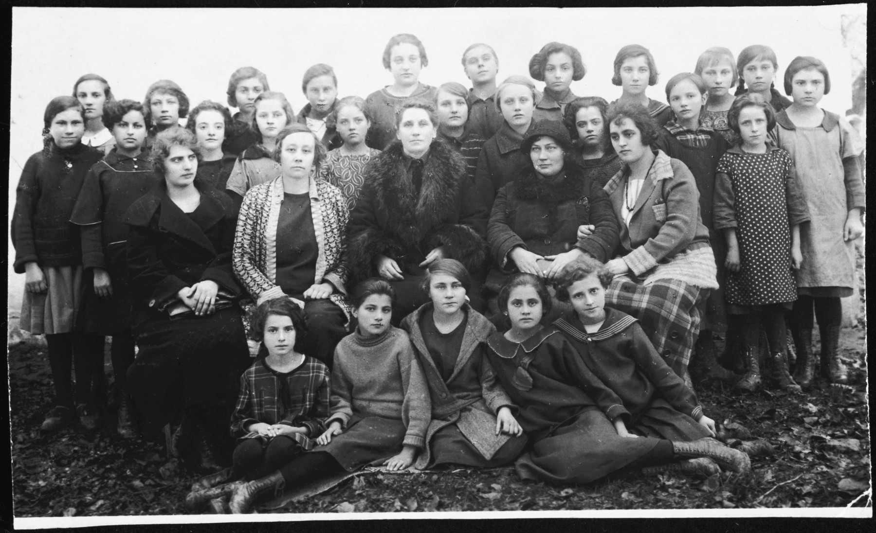 Group portrait of girls and faculty in a Polish school in Grzymalow