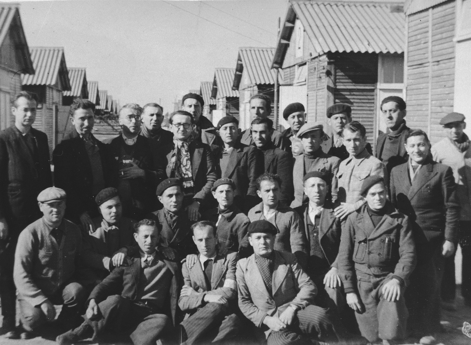 Group portrait of male prisoners in front of the barracks of the Beaune