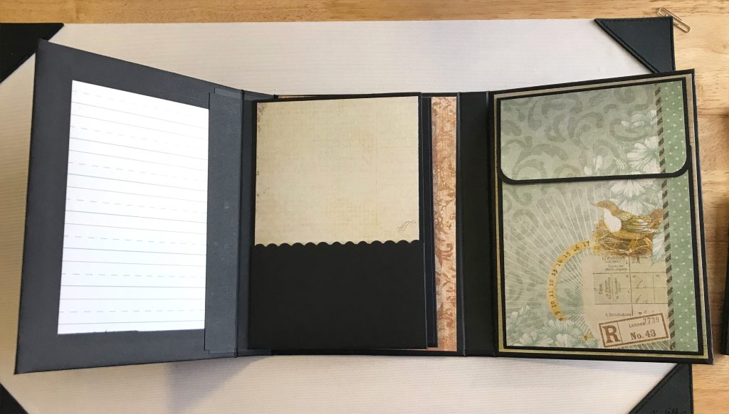 Photo of the Tri-fold Folio Album open to show the inside left and right covers as well as the first of 2 large pocket pages.