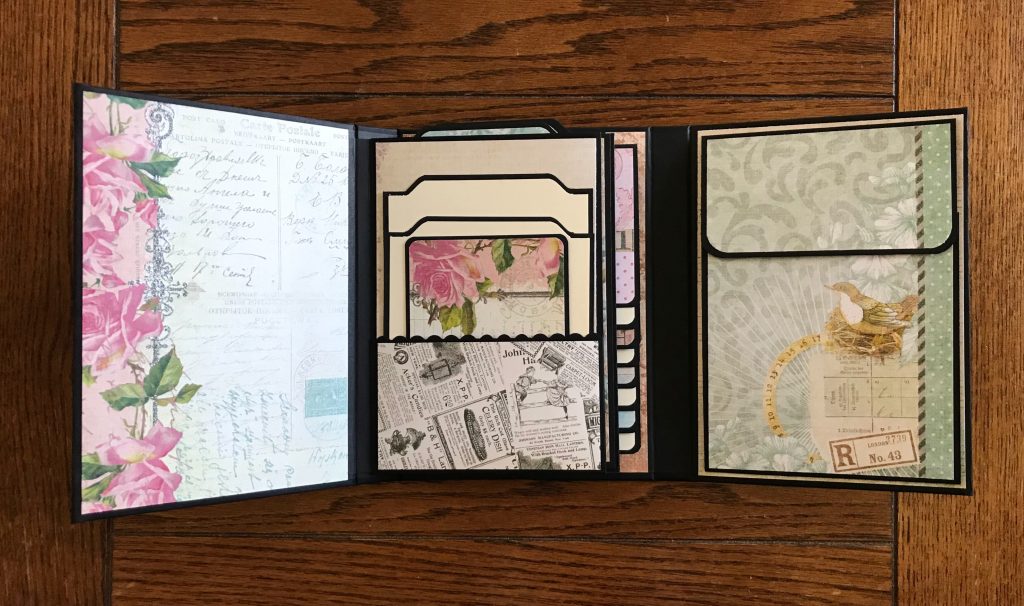 Photo of the left and right cover open to reveal the pocket ont he right side and the first of two large pocket pages int he center for today’s Tri-fold Folio Album Flip Through post. 