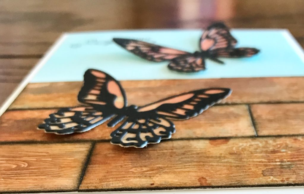 Photo showing the dimension by only gluing down the center of the butterflies to the card front for today's Happy Spring Butterfly Card.